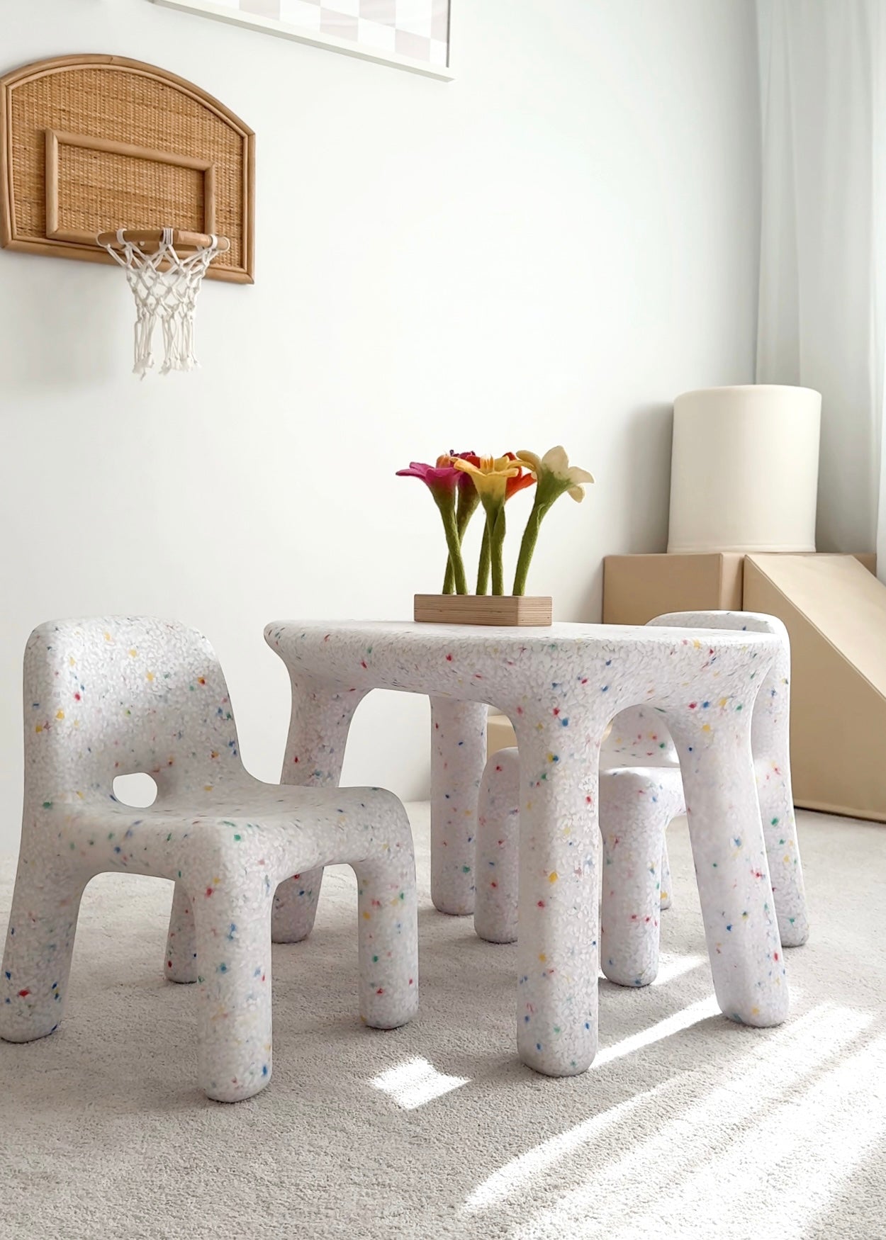 Children's furniture set with stools and a small table in a room with a basketball hoop on the wall.